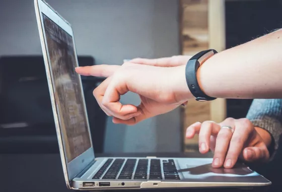 Advice: Understanding our open licence People pointing at a laptop screen