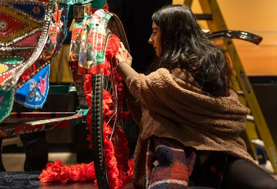 Rickshaw being painted as part of the South Asia Gallery at Manchester Museum. Credit: Manchester Museum Person painting a rickshaw on display in the South Asia Gallery at Manchester Museum