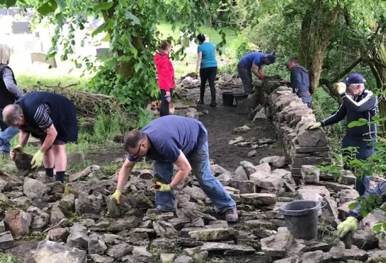 Volunteers have learned new skills so they can care for St Nicholas Church's dry stone walls in Rossendale, Lancashire Volunteers work on rebuilding dry stone walls at St Nicholas Church,