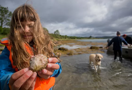 Join us in sharing your #PlanetaryPromise this week Young girl holding an oyster