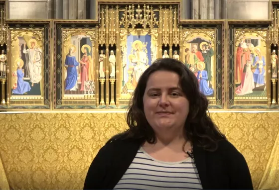 Person stood in Hereford Cathedral. They are talking to the camera.