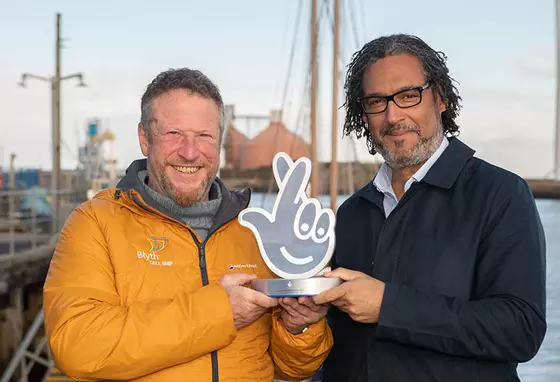 Clive Gray from Blyth Tall Ships accepts a National Lottery Award from historian David Olusoga
