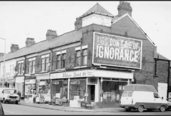 Pride! Prevention! Protection! Let’s Talk About Sex Old photo showing large billboard with the words "AIDS: don't die of ignorance"