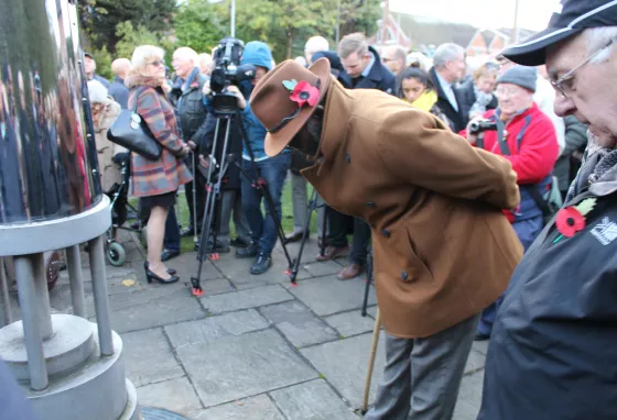 Changing lives: Johnson digs deep and reunites with mining colleagues Man at memorial event