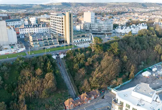An aerial view of Leas Lift on the cliff edge with town buildings above
