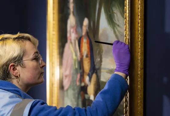 The reopening of the National Portrait Gallery. Credit: David Parry A close up of a person conserving a painting on display in the National Portrait Gallery