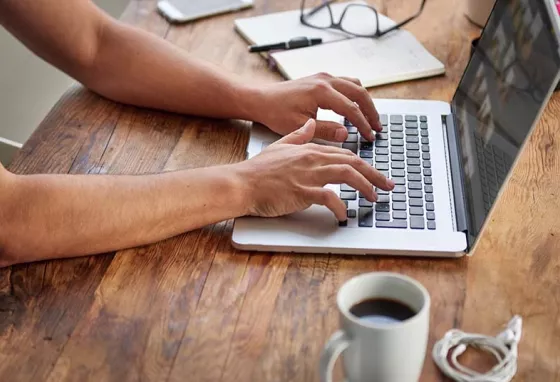 £2million to help heritage sector build back after the pandemic Man typing on laptop on desk