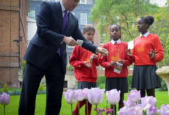 Political leaders mark the success of First World War: Then and Now The Prime Minister planting poppy seeds with local school children