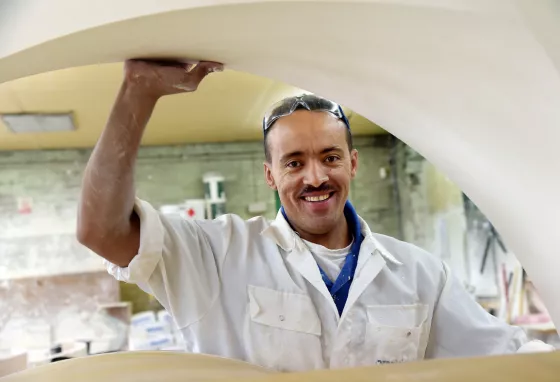 Changing lives: Ameha goes from pizzas to plaster to prizewinner A man holds plaster