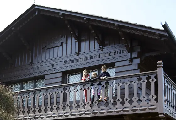Childhood at Osborne Children on balcony of wooden playhouse