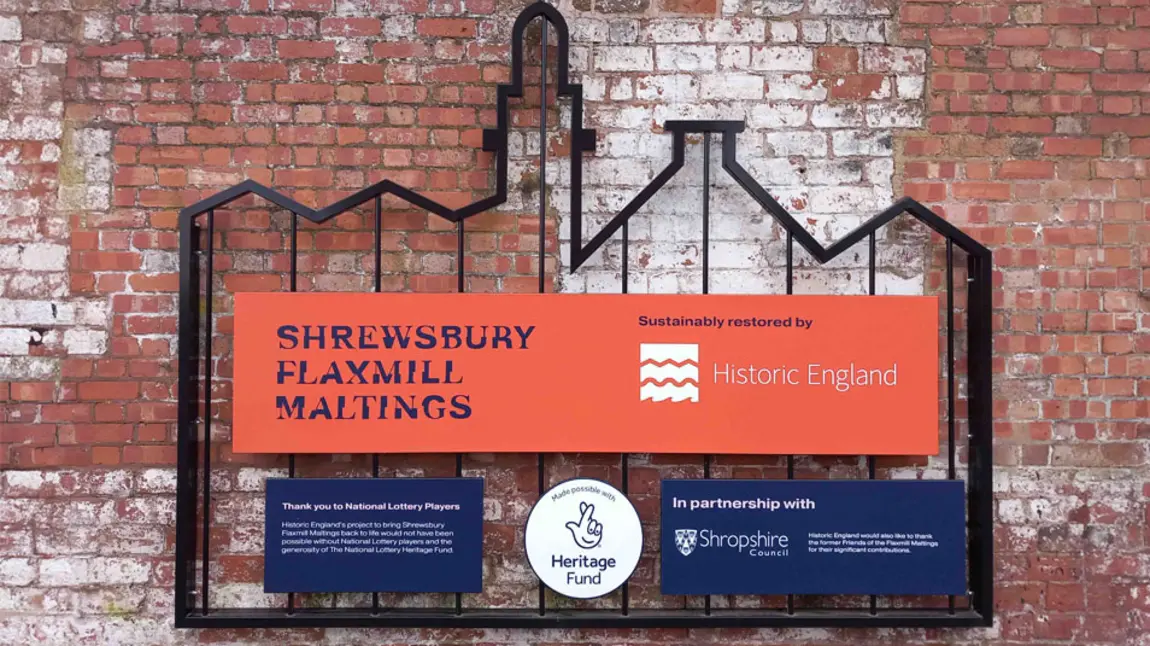 a metal frame in the shape of the building with The National Lottery Heritage Fund acknowledgement stamp mounted on it