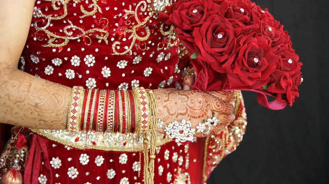 Manchester is invited to a Big Fat Asian Wedding! A bride holds a wedding bouquet