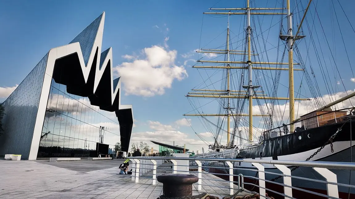 Glasgow's Riverside Museum. A view of the facade of the Riverside Museum in Glasgow, opposite a docked tall ship in the Clyde.