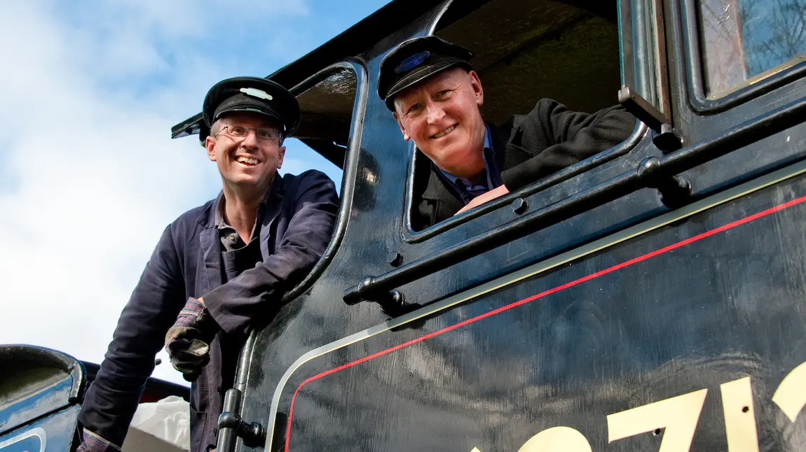 Two men in a steam train