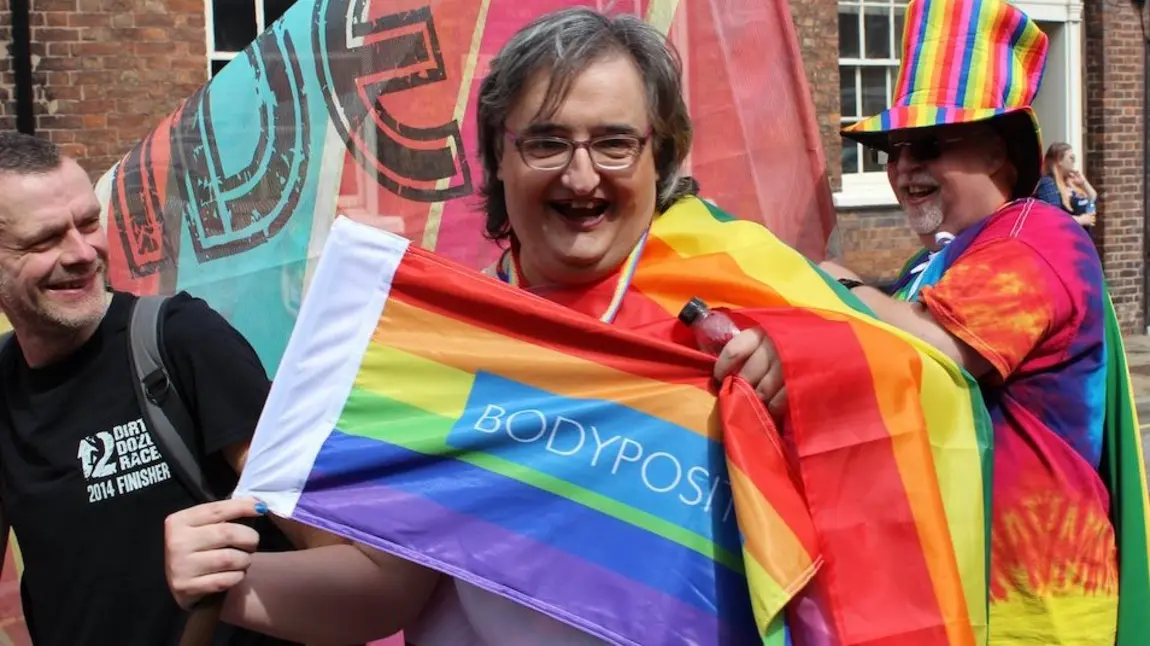 Woman with rainbow flag at Chester Pride