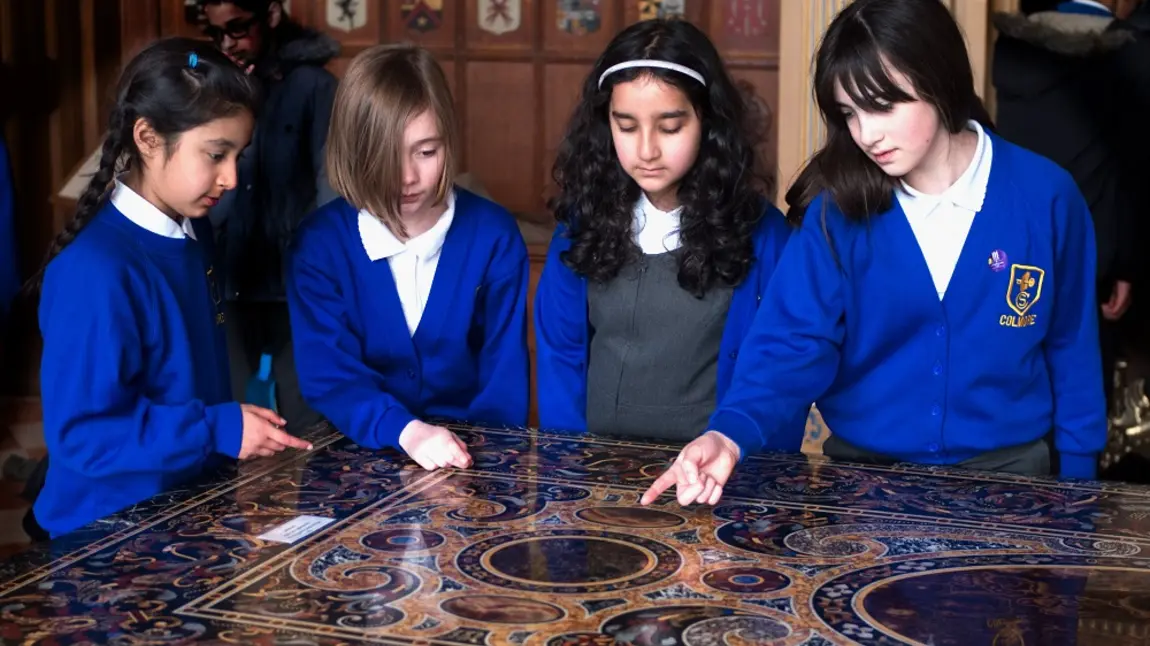 Children gathered around a table at a National Trust Property
