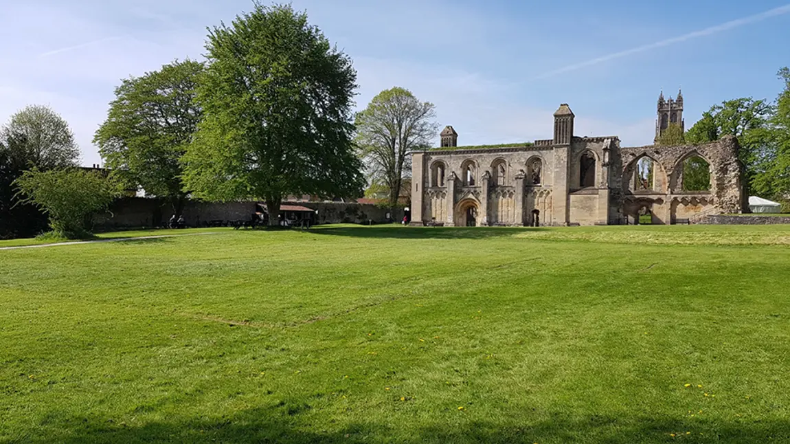 Glastonbury Abbey with a lawn foregrounded