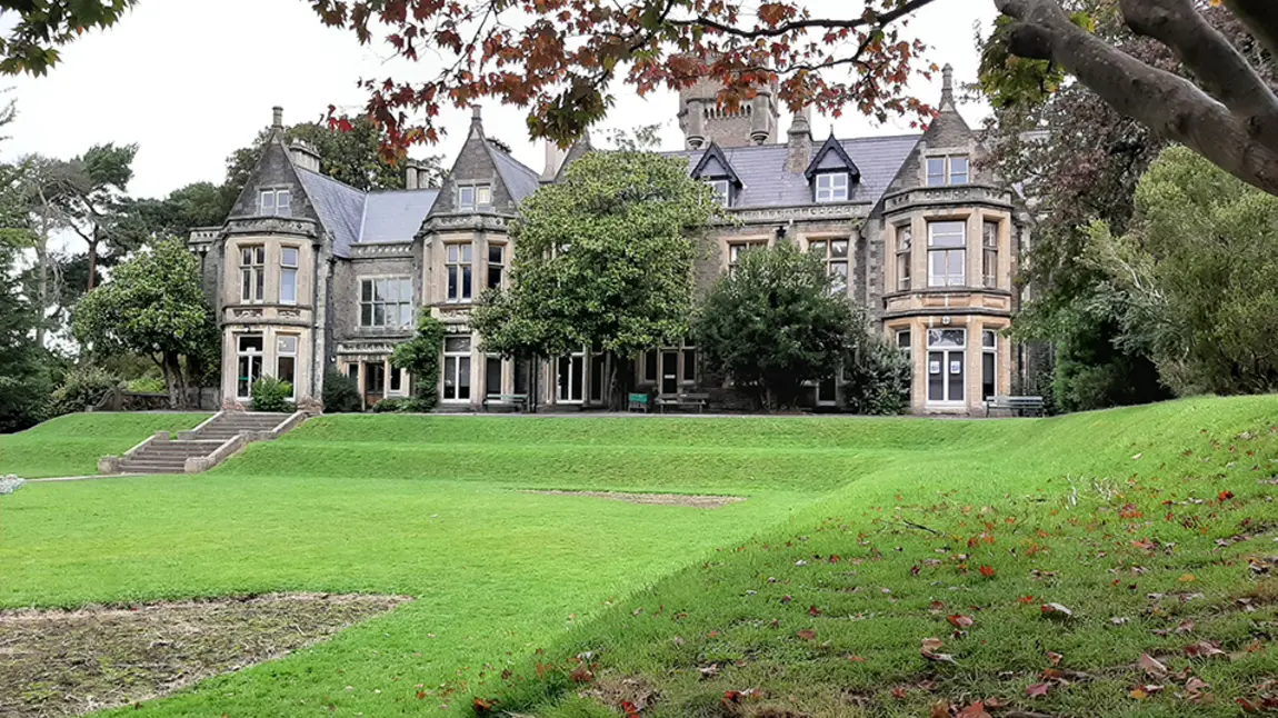 A large mansion with lawn in front