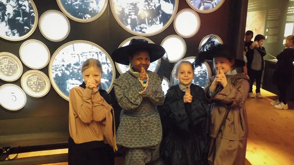 National Lottery Awards 2021 shortlist announced – which project gets your vote? Four children face camera smiling. They are dressed in historic outfits. They are near an exhibition.