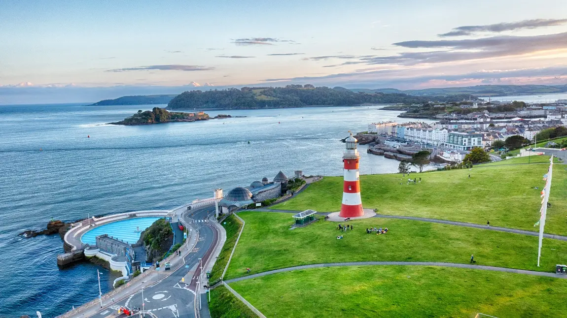 Aerial view of Plymouth's coast, with the lighthouse and lido in view