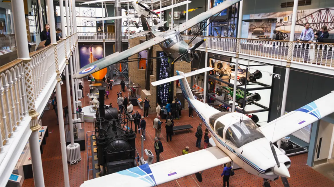 Interior view of the National Museum of Scotland featuring planes suspended from the ceiling