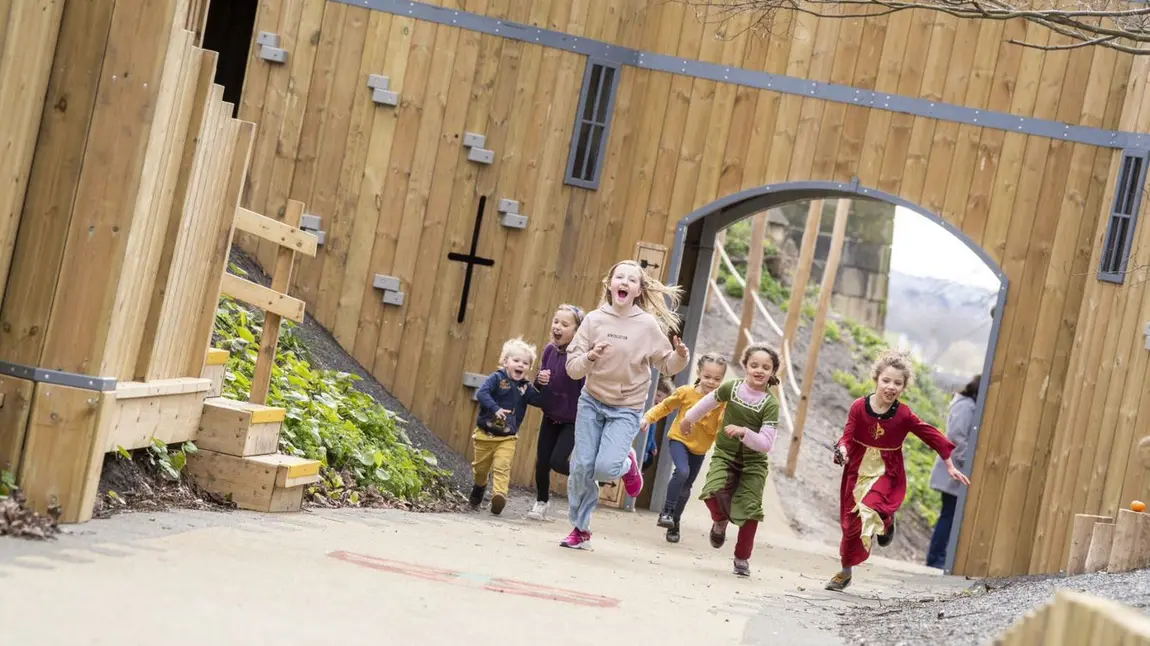 Children running through large arch