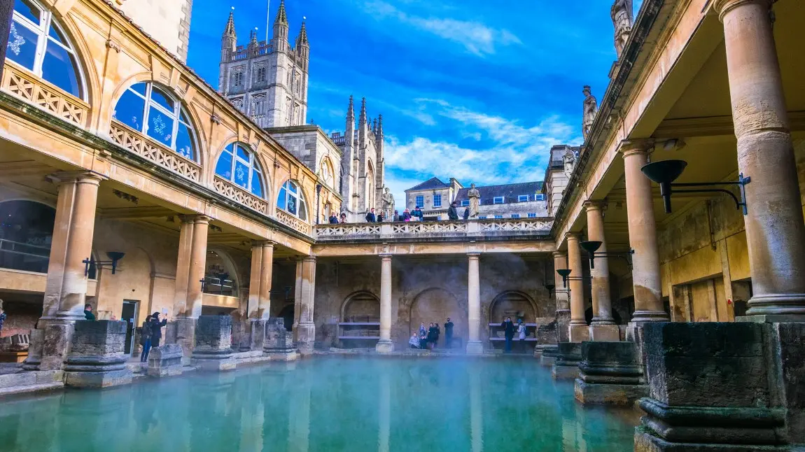 View of The Great Bath in Bath, Somerset, showing the water surrounded by Roman architecture.