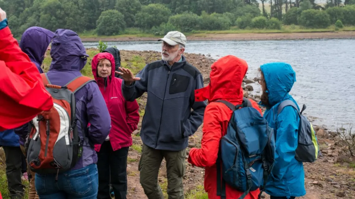 People in anoraks learning about Cairngorms