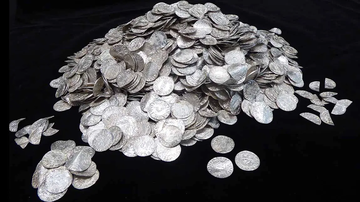 The Chew Valley Hoard A large pile of silver coins on a black background