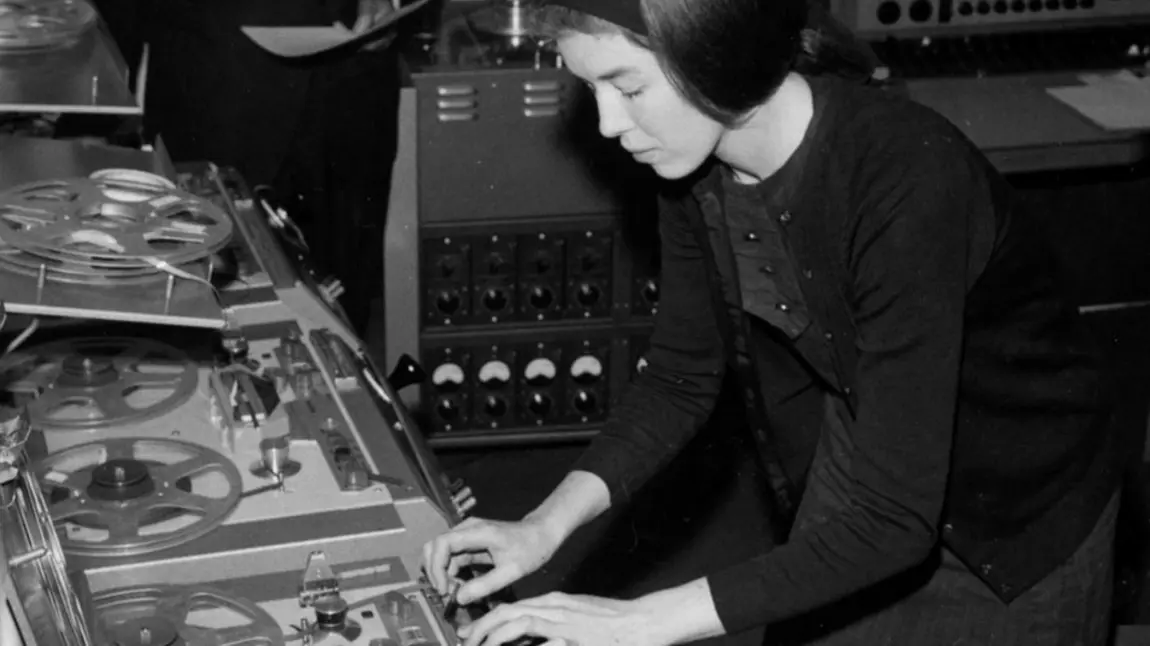 A black and white photograph of Delia creating electronic music.