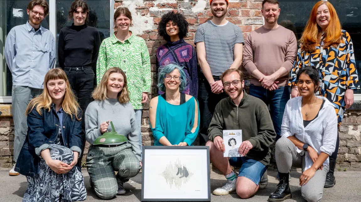 A group of people stand together with the Delia Derbyshire collections