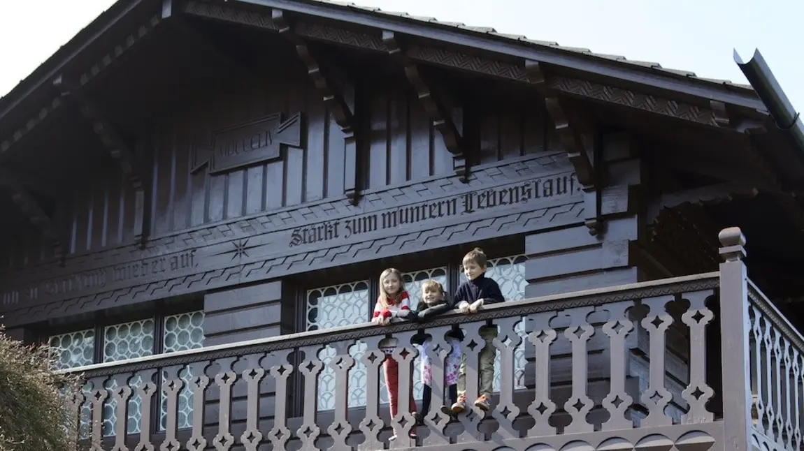 Children on balcony of wooden playhouse