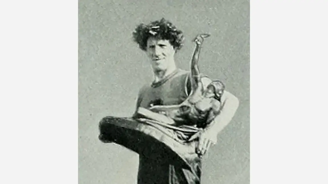 A black and white image of K K McArthur with the trophy