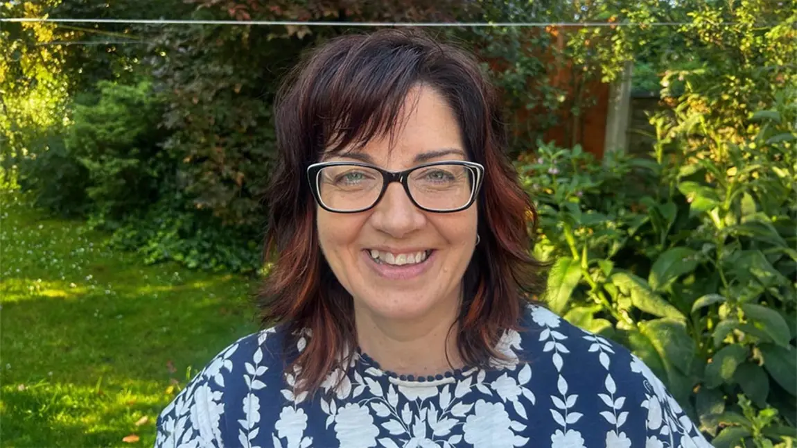 Heather McLachlan A woman with brown hair and glasses in a garden