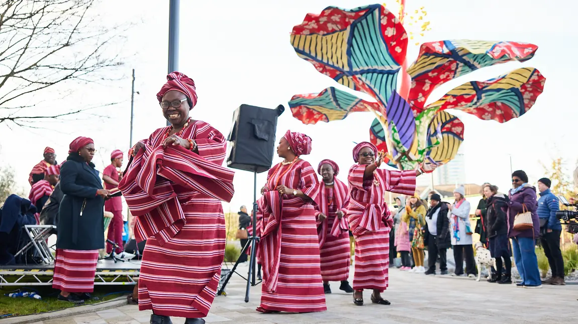 A group of people wearing Nigerian traditional clothes, celebrating the launch of Hibiscus Rising.