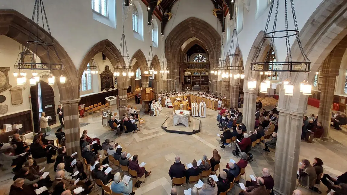 A photo of the inside of Leicester Cathedral during a service, taken from a high perspective within the building