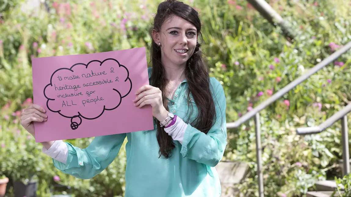 Young woman holding sign