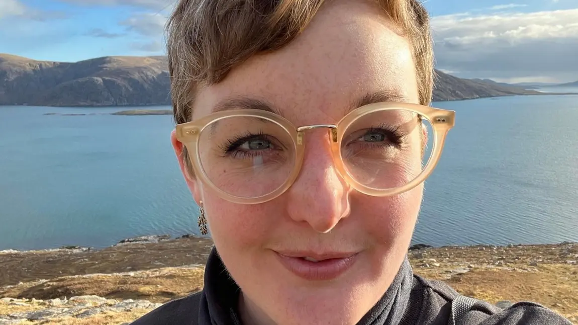 A person is smiling at the camera.
