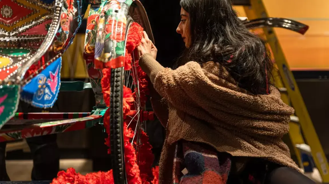 A person paints a rickshaw as part of the South Asia Gallery at Manchester Museum