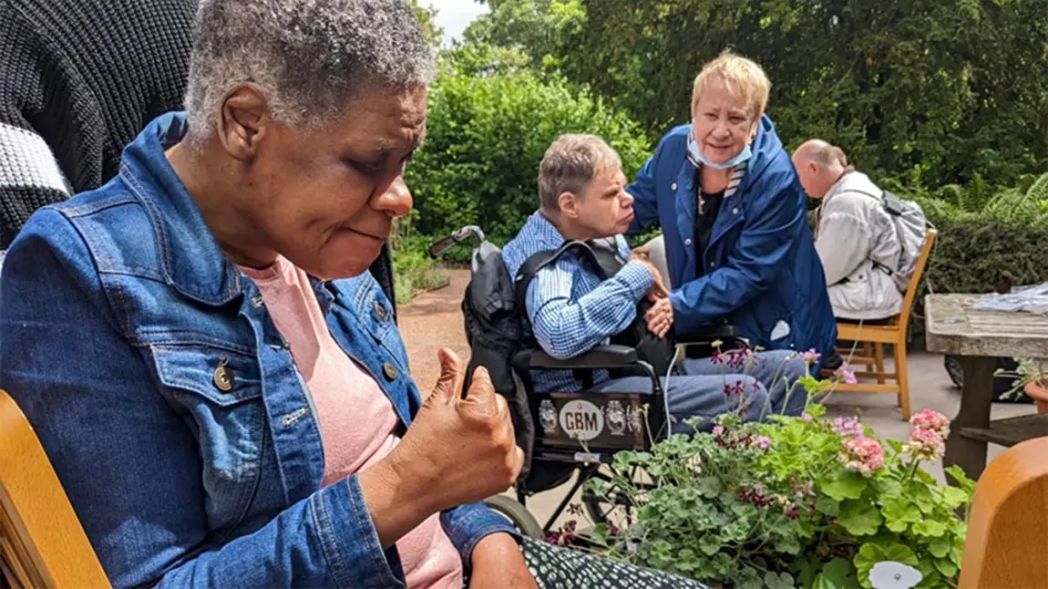 Adults with complex care needs in a garden