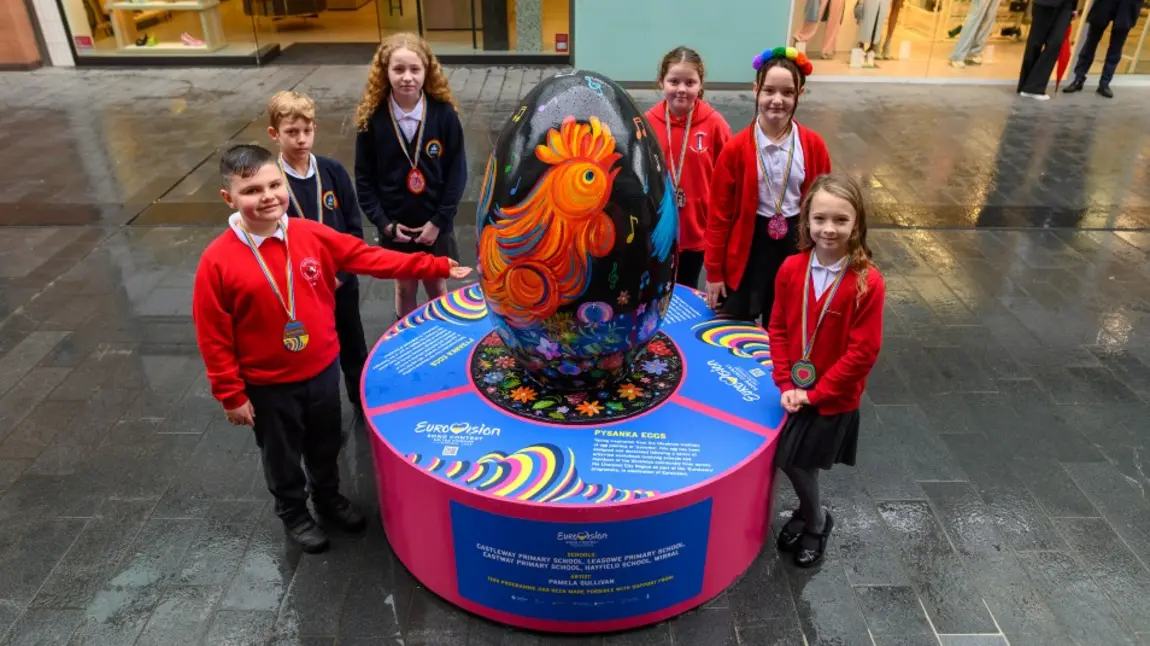 Children stand next to pysanka egg display for Eurovision celebrations