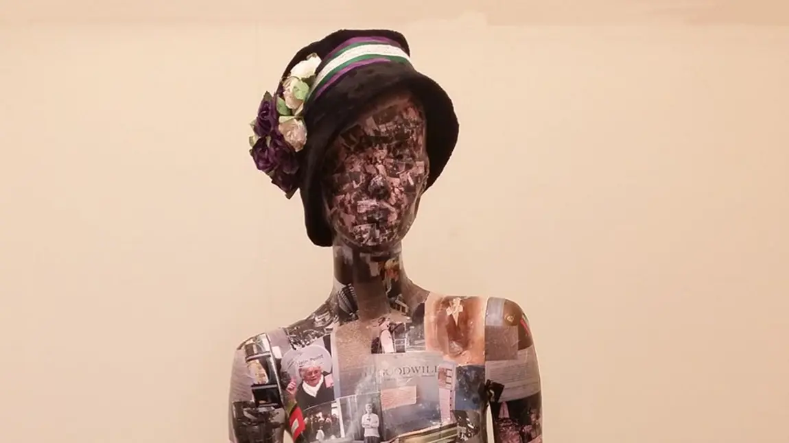 A mannequin covered in photos and documents. Volunteers created the 'Wo-Mannequin' from photos of the research, visits and materials they collected during the project