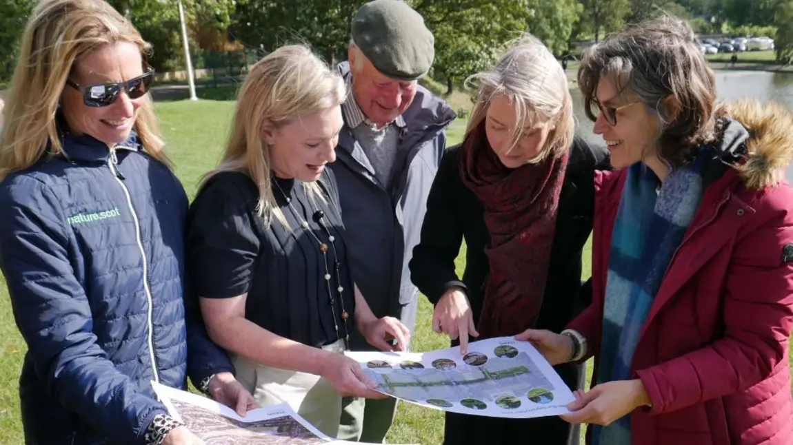 Edinburgh Garden City at Inverleith Park Five people in a park looking at plans on A3 size paper