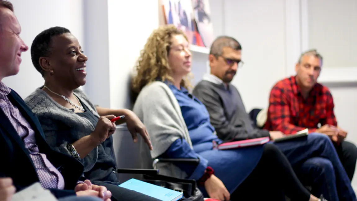 A group of people taking notes in a workshop