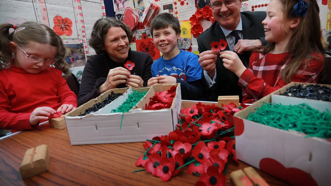 Children and adults making poppies