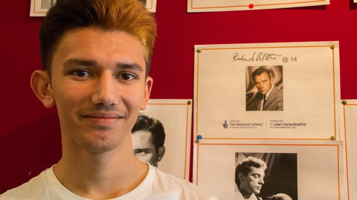 Changing lives: instilling confidence in Port Talbot teens Abdul next to the project display