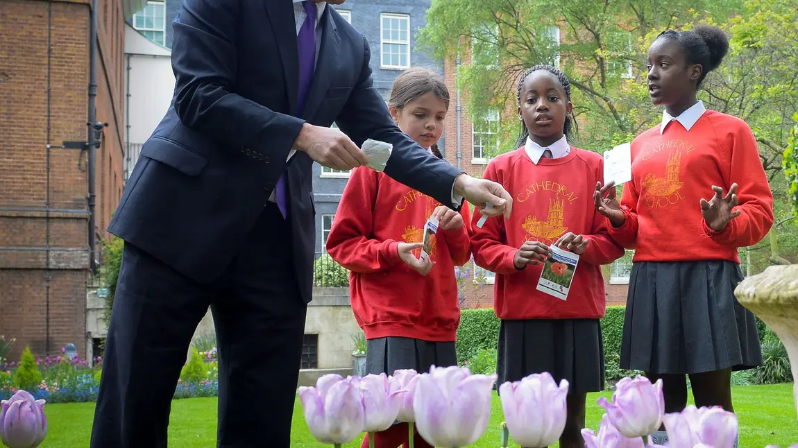 The Prime Minister planting poppy seeds with local school children