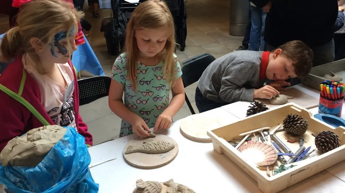 Children make clay fish