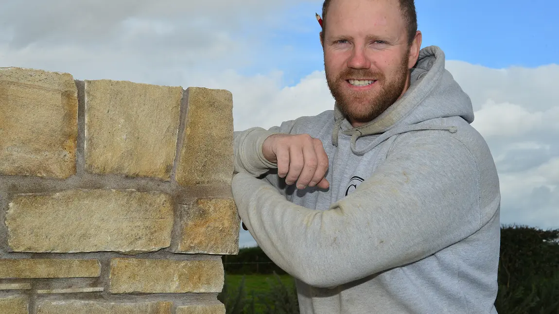 Changing lives: for Conor there’s no place like stone… Conor Scullion posing next to some stonework