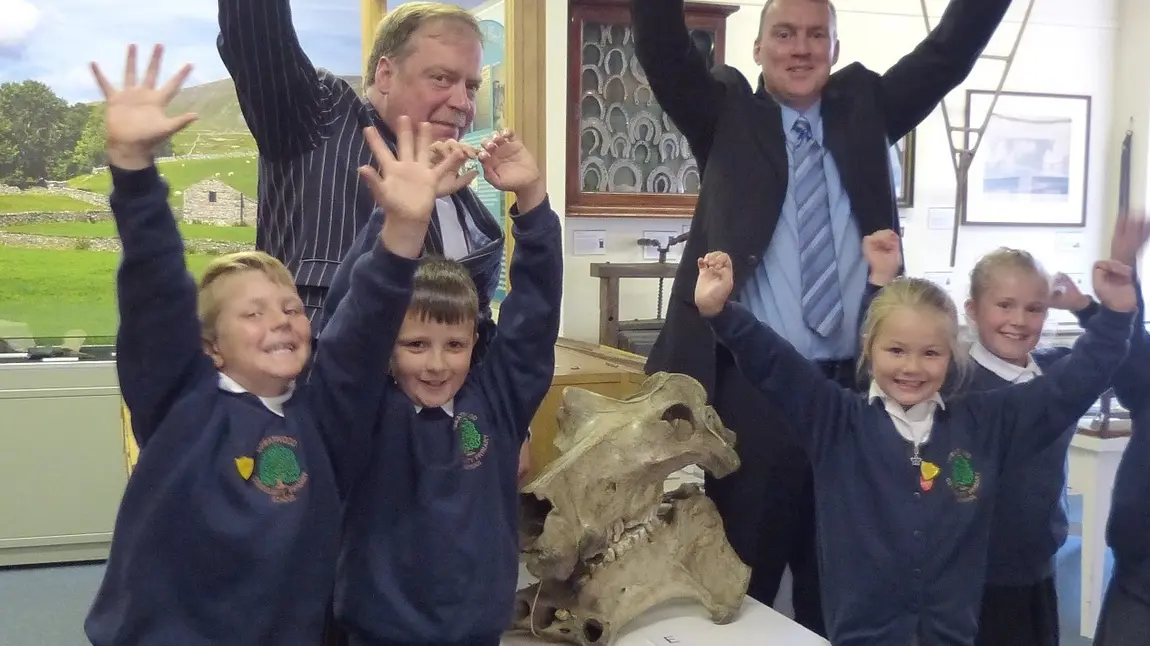 Pupils from Greatwood Primary School, Cllr Simon Myers and Paul Ellis (Director of Services) celebrate Craven Museum and Gallery first round pass
